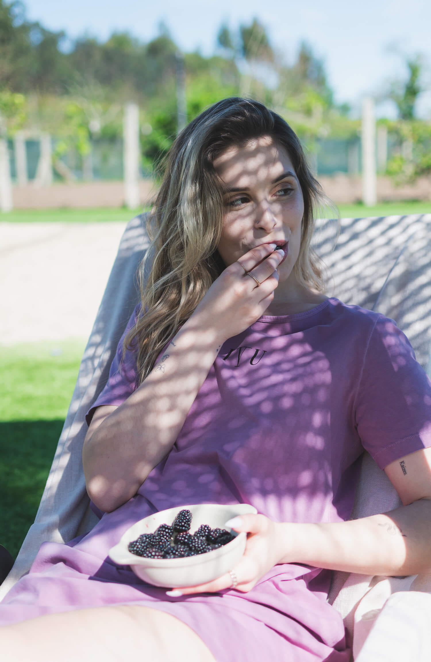 Model wearing the naturally dyed organic cotton Shellac nightshirt, lifestyle photo outdoors.