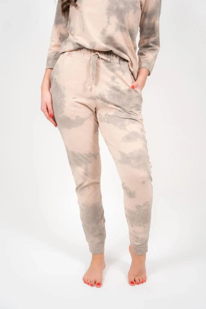 Organic cotton Alkanna Spray pajama pants on model, naturally dyed with onion skins and hand-sprayed of Alkanna tinctoria, front view, full-length studio shot